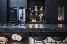 a contemporary black kitchen with a large kitchen island with a marble countertop, built-in lights and metal stools