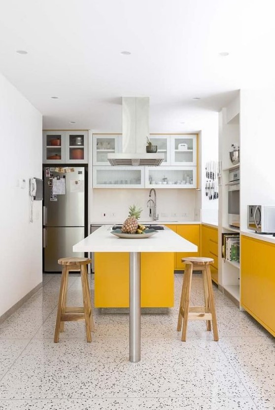 a contemporary kitchen done with sunny yellow and white cabinets, with white countertops and a mosaic floor looks cool