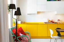 a contemporary kitchen with white and yellow cabinets and built-in lights plus colorful touches for more