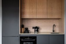 a minimalist black kitchen with sleek cabinets, a wooden backsplash and upper cabinets plus black fixtures for more chic
