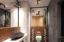 a minimalist industrial space with stone tiles, wooden accents, large mirrors and exposed pipes that are lamps