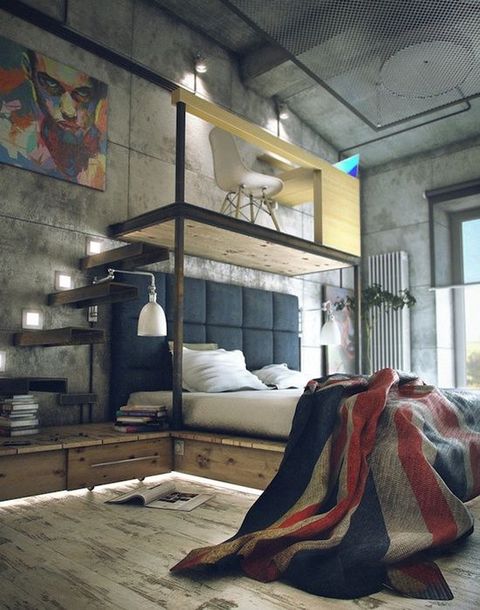 a modern industrial space with concrete walls, a shabby wood floor, a floating bed with storage, a platform with a work space on top