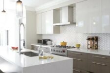 a modern space with sleek white cabinets and stained ones, a geo tile backsplash and a marble kitchen island