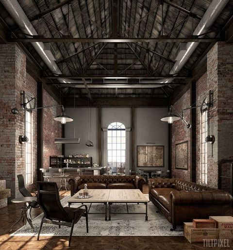 a moody industrial living room with red brick walls, a high ceiling with metal beams, leather chairs and sofas and wooden tables