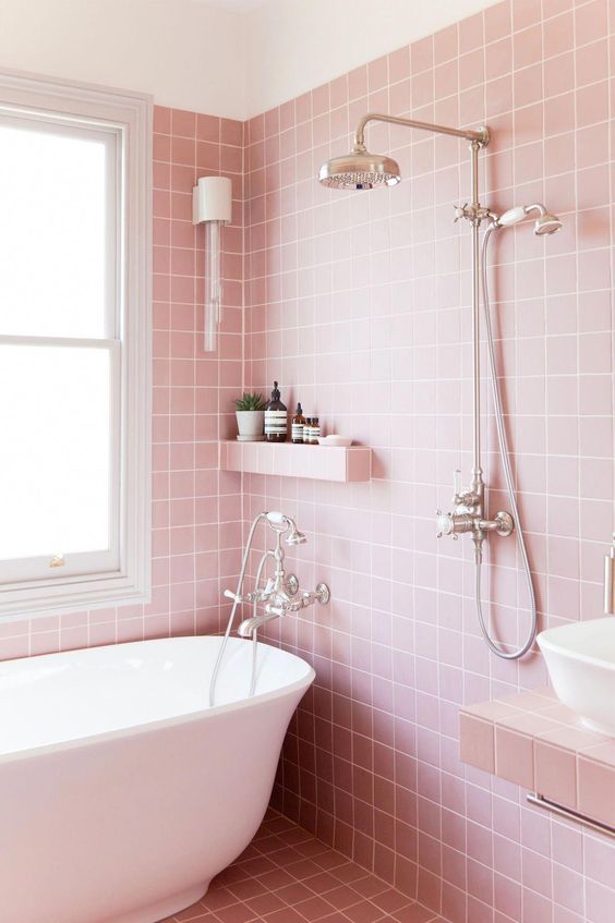 a pretty light pink bathroom with white appliances and vintage fixtures looks very girlish and very cute