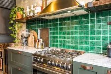 a stylish olive green kitchen with leather handles, a bold green tile backsplash and open shelves plus white stone countertops