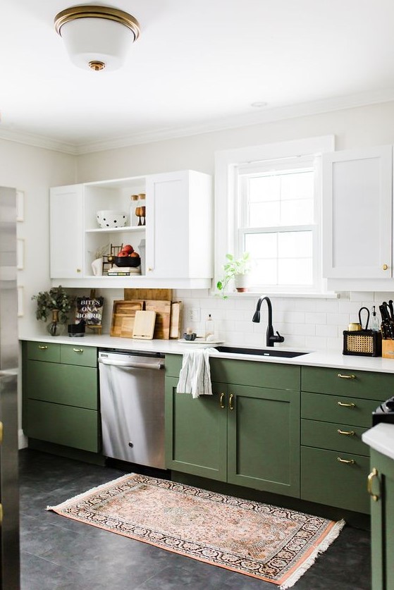 a stylish two tone kitchen with green and white shaker cabinets, white countertops and black fixtures plus touches of brass