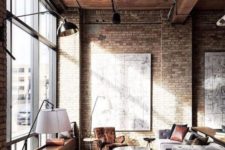 a welcoming industrial living room with brick walls, a wooden ceiling, metal beams and lamps, cozy retro furniture and rugs