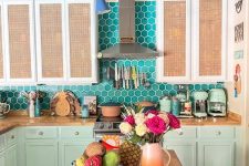 a whimsy kitchen with mint and cane cabinets, a turquoise hex tile backsplash and butcherblock countertops