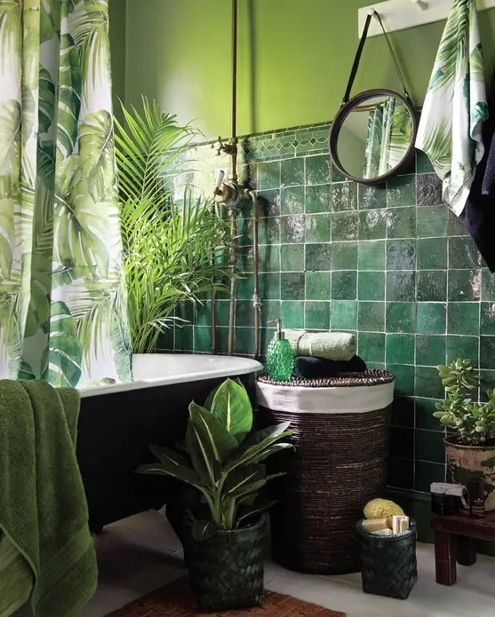 dark green tiles paired with light green wall, lots of greenery and a tropical print curtain for a tropical feel