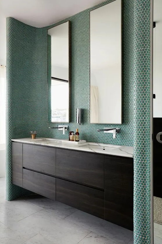 emerald penny tiles covering the sink zone highlight it and make a statement for a chic modern look