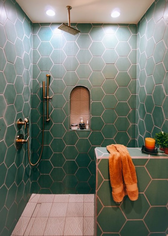green hex tiles with copper grout make up a chic and bold bathroom space