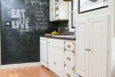 02 a white farmhouse kitchen with gold or brass touches, a chalkboard wall for marks and a grey tile backsplash
