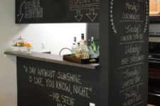 a stylish idea to cover a kitchen island with chalkboards