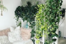 07 a storage unit that doubles as a space divider covered with climbing plants turns your home into a jungle