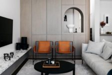 10 a modern luxurious living room with amber leather chairs that add texture and color to the space