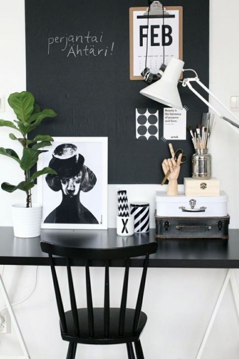 a monochromatic home office with a chalkboard wall used as a memo board - for makign notes, for attaching stickers and other stuff