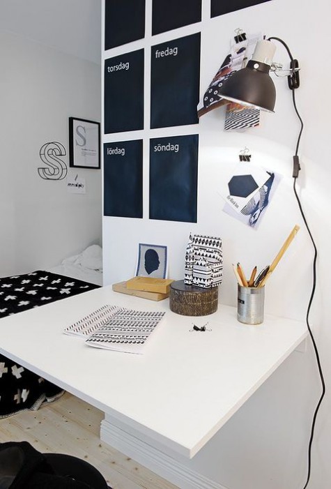 a Nordic home office nook with a chalkboard calendar - these black stickers are for each day of the week