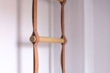 23 a towel holder in the bathroom made of leather straps and wooden sticks is a stylish modern accessory to make