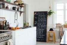 25 a white Nordic kitchen with an oversized chalkboard sign that you can bring to make notes and marks of all kinds