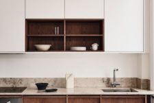 a chic minimalist kitchen with neutral cabinets, wooden ones and a tan stone countertop plus backsplash for a warmer look