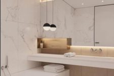 a luxurious minimalist bathroom with white marble large scale tiles, plywood panels, a large lit up mirror and a pendant lamp