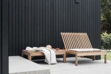 a minimalist terrace with a concrete bench, a wooden bench and lounger is very stylish