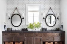 a modern farmhouse bathroom with subway tiles, a dark wooden frame on the ceiling and matching vanity plsu baskets