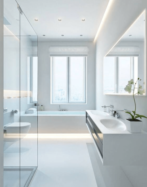 A pure white minimalist bathroom with a floating vanity, a bathtub with built in lights, a shower clad with glass and a window