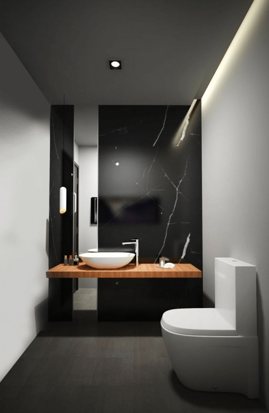 a refined minimalist powder room with a black marble wall, a floating vanity, white walls, white appliances and built-in lights