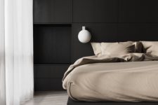 a super stylish minimalist bedroom with a black storage headboard and a black bed, bubble sconces and neutral bedding