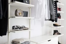 a white airy minimalist closet with drawers, open shelves, boxes and a holder for hangers