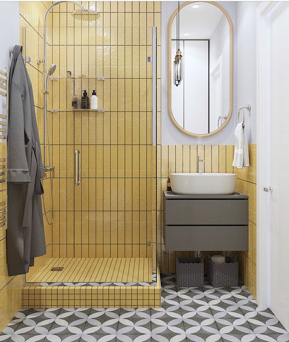a small minimalist bathroom with a shower clad with mustard skinny tiles and white and grey for a contrast