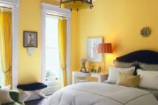 03 a whimsical bedroom with bright yellow walls and curtains, with navy and green furniture and a chic pendant lamp