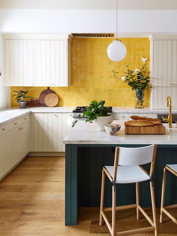 a stylish neutral kitchen with a hunter grene kitchen island and a sunny yellow zellige tile backsplash for a bright touch