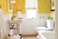 11 a bright vintage bathroom with sunny yellow wallpaper, white tiles and white appliances with a vintage feel