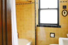 12 a bright vintage bathroom with yellow tiles, black touches for drama and white vintage appliances