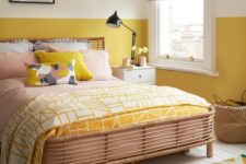 12 a cheerful bedroom with mustard color block walls, bright bedding, an artwork feels sunny and welcoming