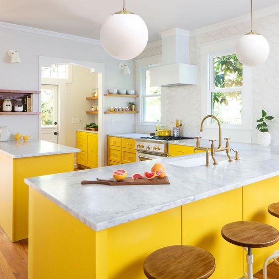 a chic farmhouse kitchen with sunny yellow cabients and all neutrals around feels airy and bright