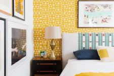 15 a bold eclectic bedroom with a yellow wallpaper wall, bright bedding and a bright gallery wall