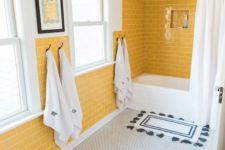 15 a cheerful bathroom with yellow tile walls, a penny tile floor and white appliances for a chic look