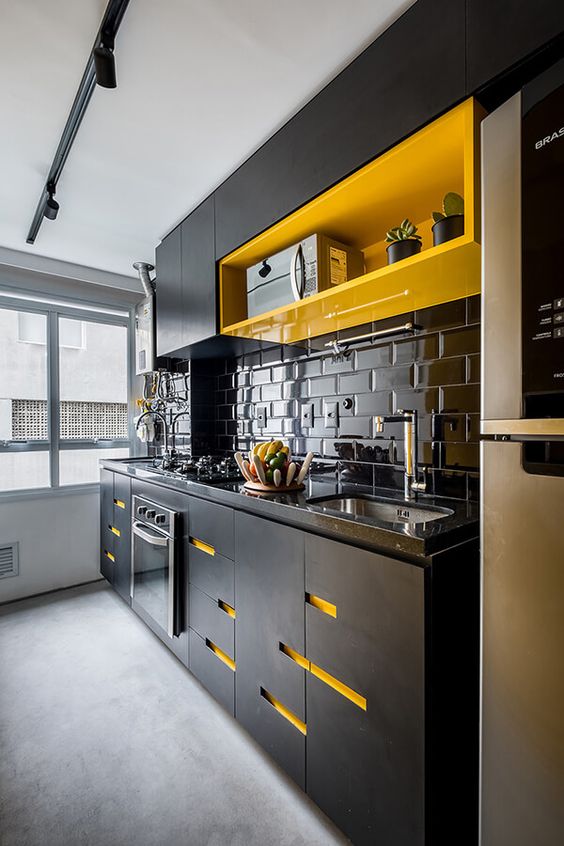 a contrasting black kitchen with bright yellow touches - an open shelf and cutout handles is super bold