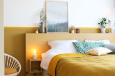 19 a chic and bold bedroom with a mustard color block wall and mustard and green bedding for a cozy feel