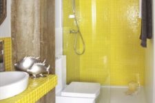 22 a bright bathroom with yellow tiles in the shower and a bright tile vanity, white large scale tiles and industrial wooden beams