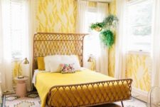 22 a bright mid-century modern bedroom with yellow wallpaper walls, bright mustard bedding and a bright rug