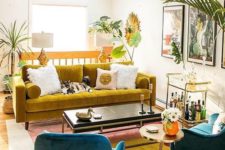 a bold mid-century modern living room with a mustard velvet sofa and a color block rug plus lots of tropical plants