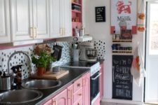 a bright and fun kitchen with white upper cabinets, hot pink lower ones and a pretty dolmatin print backsplash