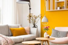 a bright contemporary living room with a mustard accent wall and a pillow plus simple neutrals and black touches