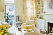 a cozy living room with striped yellow walls, patterned yellow furniture and textiles and all neutrals around