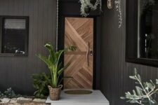 a lovely porch with a geometric wooden front door